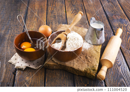 Fresh ingredients for delicious homemade cake on white wooden table Fresh ingredients for delicious homemade cake on white wooden table 111004520