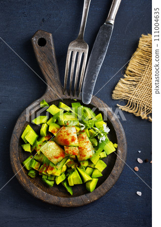 Diet avocado salad with cucumber and green onions Diet avocado salad with cucumber and green onions 111004635