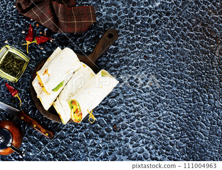 Salmon and cream cheese wraps. Rolls with smoked salmon, basil and rocket salad. Burrito on serving board 111004963