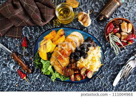 Grilled chicken breasts with French fries and vegetables 111004968
