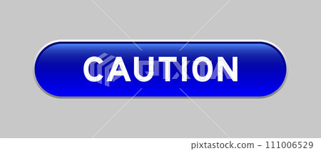 Blue color capsule shape button with word caution on gray background 111006529