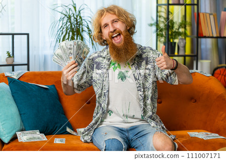 Successful happy rich business man counting money cheering up with high profits, lottery game win 111007171