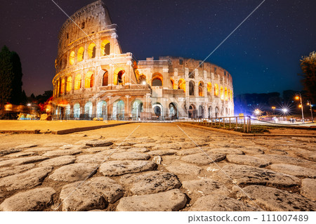 Rome, Italy. Colosseum Also Known As Flavian Amphitheatre In Night. Calmness Night Time. Bright Blue Night Starry Sky. Amazing Star Sky. Travel Italy Concept. Spirit Of Travel. Zeitgeist 111007489