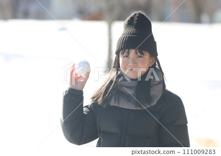 girl throwing snowballs 111009283