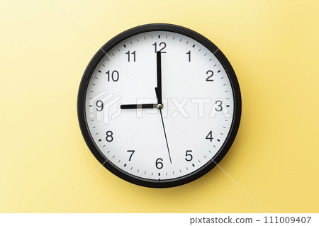 wall clock on yellow background 111009407
