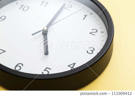 wall clock on yellow background 111009412