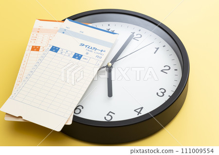 Wall clock and time card on yellow background Wall clock and time card on yellow background 111009554