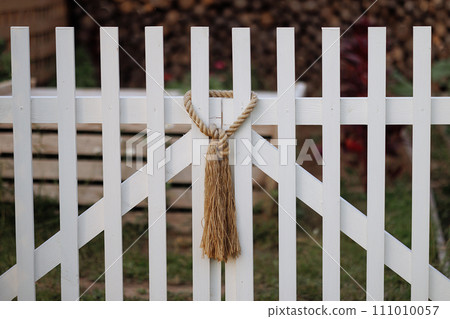 Rope knot on white picket fence. Rope knot on white picket fence. 111010057