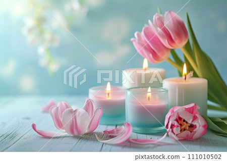 Pink yellow tulip flowers, lit candles on rustic wooden background. Greeting card 111010502