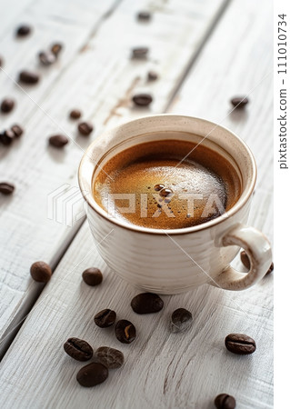 Cup of aromatic black coffee on a white rustic wooden background 111010734
