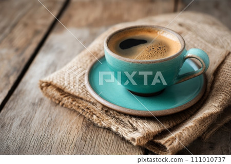 Cup of aromatic black coffee on a brown wooden background 111010737
