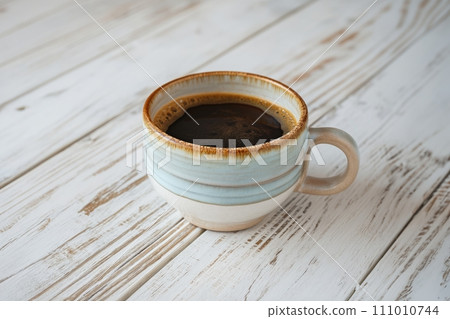 Cup of aromatic black coffee on a white rustic wooden background 111010744