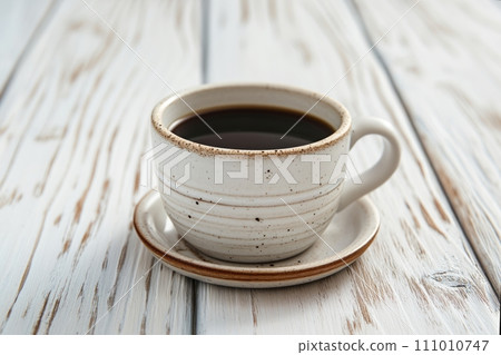 Cup of aromatic black coffee on a white rustic wooden background 111010747