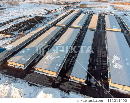 Drone view of a rental storage unit facility with closed bay doors. Drone view of a rental storage unit facility with closed bay doors. 111011400