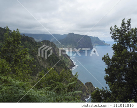 Views from Vereda do Larano coastal hiking trail. Cliffs atlantic ocean and green tropical vegetation. Madeira island, Portugal, Europe. 111011816