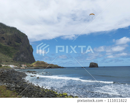 View of Porto da Cruz village with black stone beach and sea water swimming pool. Madeira Island, Portugal 111011822
