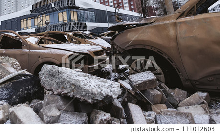 Kyiv, Ukraine - January 3, 2024: Burned civilians cars after a Russian's missiles attack Kyiv, Ukraine - January 3, 2024: Burned civilians cars after a Russian's missiles attack 111012603