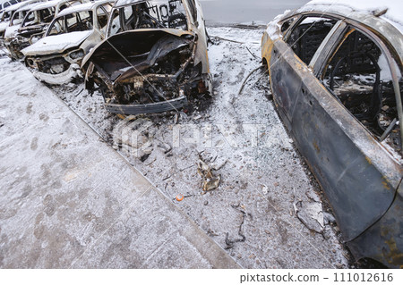 Kyiv, Ukraine - January 3, 2024: Burned civilians cars after a Russian's missiles attack Kyiv, Ukraine - January 3, 2024: Burned civilians cars after a Russian's missiles attack 111012616