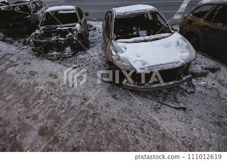 Kyiv, Ukraine - January 3, 2024: Burned civilians cars after a Russian's missiles attack Kyiv, Ukraine - January 3, 2024: Burned civilians cars after a Russian's missiles attack 111012619