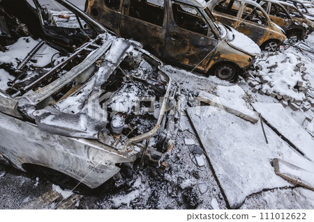Kyiv, Ukraine - January 3, 2024: Burned civilians cars after a Russian's missiles attack Kyiv, Ukraine - January 3, 2024: Burned civilians cars after a Russian's missiles attack 111012622
