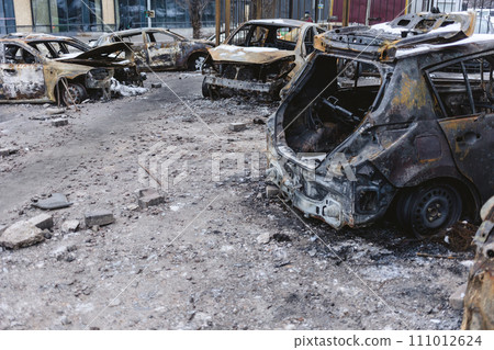 Kyiv, Ukraine - January 3, 2024: Burned civilians cars after a Russian's missiles attack Kyiv, Ukraine - January 3, 2024: Burned civilians cars after a Russian's missiles attack 111012624