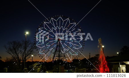 Ferris wheel illuminated during magic hour 111013026