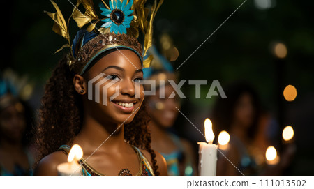 Young joyful African American woman in a carnival costume and holding a candle 111013502