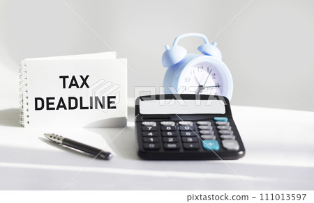 Notepad with text message TAX DEADLINE. Conceptual image Notepad with text message TAX DEADLINE. Conceptual image 111013597