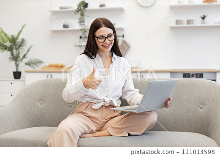 Confident brunette woman in talking on webcam and gesturing with hands. 111013598