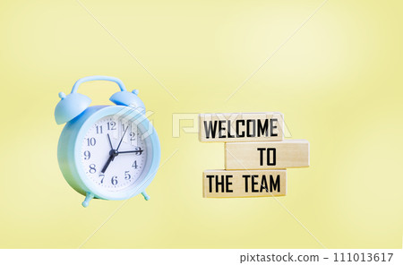 Concept words Welcome to our team on wooden blocks. Beautiful yellow background. Copy space. 111013617
