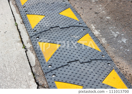 Orange restrictive poles on the road closeup 111013700
