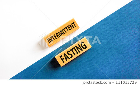 Intermittent fasting symbol. Concept words Intermittent fasting on beautiful wooden block. Beautiful white and blue background. Healthy lifestyle intermittent fasting concept. Copy space. Intermittent fasting symbol. Concept words Intermittent fasting on beautiful wooden block. Beautiful white and blue background. Healthy lifestyle intermittent fasting concept. Copy space. 111013729