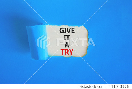 Give it a try symbol. Concept word Give it a try on beautiful white paper. Beautiful blue paper background. Business give it a try concept. Copy space. 111013976