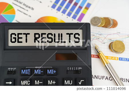 On the table are financial reports, coins and a calculator with the inscription - get results On the table are financial reports, coins and a calculator with the inscription - get results 111014096