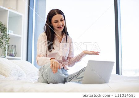 Charming female enjoying communication at distance using modern technologies. Charming female enjoying communication at distance using modern technologies. 111014585