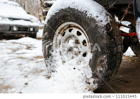 SUV wheel close-up. SUV wheel in the snow. impassable winter road SUV wheel close-up. SUV wheel in the snow. impassable winter road 111015445