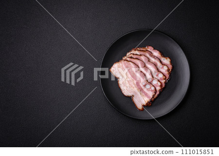 Delicious fresh pancetta or bacon with salt and spices cut into thin slices 111015851