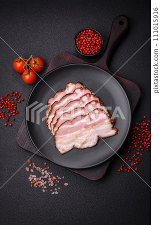 Delicious fresh pancetta or bacon with salt and spices cut into thin slices 111015916