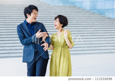 Portrait of a couple walking arm in arm 111016096