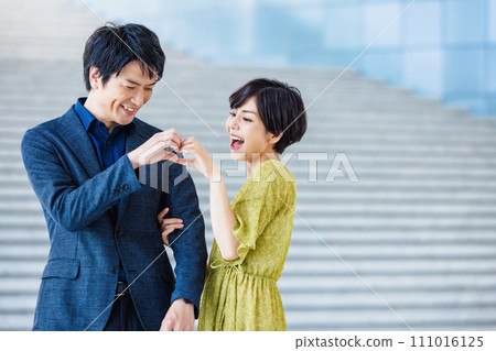 Friendly couple in heart pose 111016125