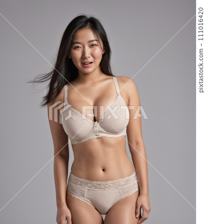 an asian woman wearing a beige bra and panties an asian woman wearing a beige bra and panties 111016420