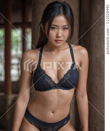 an asian woman in black lingerie posing for the camera 111016491