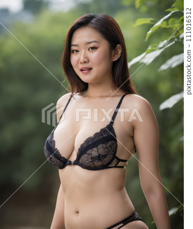 an asian woman in black lingerie posing for the camera 111016512