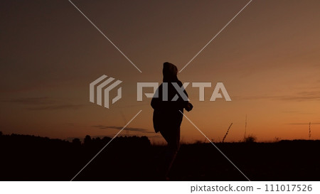 silhouette of a sporty running man, physically fit man, active activity at sunset, sports lifestyle, jogging alone, sprinting outdoors, endurance active sports man running, sportive energy of youth, 111017526