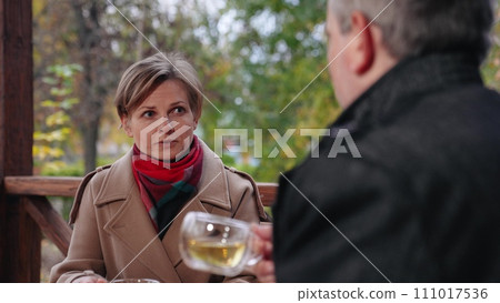 Woman explains principles of company work to man partner drinking tea. Drinking tea at business meeting with man and woman. Dialogue between man and woman entrepreneurs drinking tea at meeting Woman explains principles of company work to man partner drinking tea. Drinking tea at business meeting with man and woman. Dialogue between man and woman entrepreneurs drinking tea at meeting 111017536