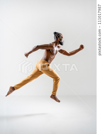 Shirtless muscular gay man running isolated on Shirtless muscular gay man running isolated on 111017987