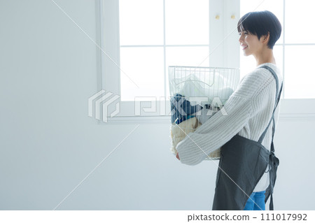 Housewife drying laundry Housewife drying laundry 111017992