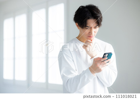 A man using a smartphone 111018021