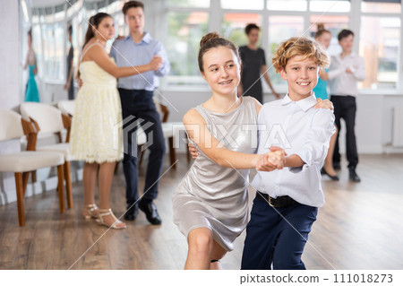 Teen boy and girl are dancing contemporary modern discofox in couple during lesson at studio Teen boy and girl are dancing contemporary modern discofox in couple during lesson at studio 111018273