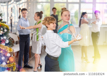 Boy and girl dancing waltz in studio 111018324